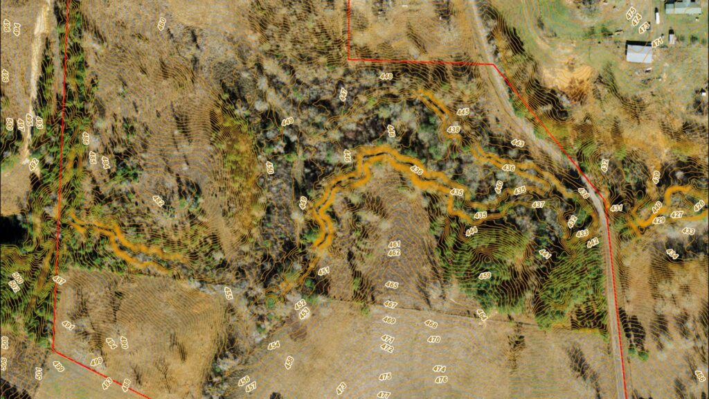 High-resolution topographic map with 1-ft contour lines showing watershed flow patterns, elevation data, and riparian zones on a Central Texas property.